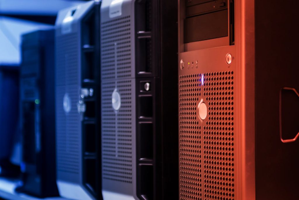 pexels photo 17489151 Close-up of tower servers in a data center with blue and red lighting.